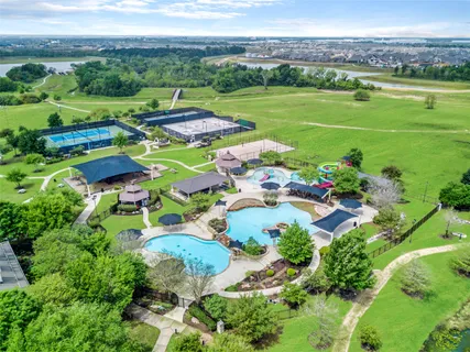 an aerial view of a houses with outdoor space and a lake view