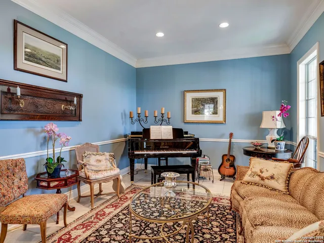 a view of a dining room with furniture and chandelier