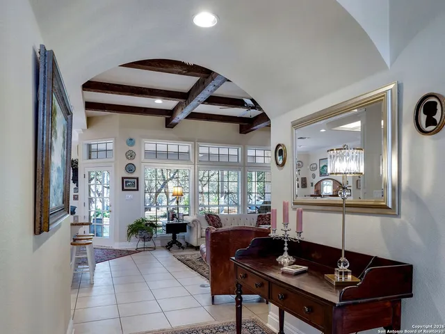 a living room with furniture a rug and a large window