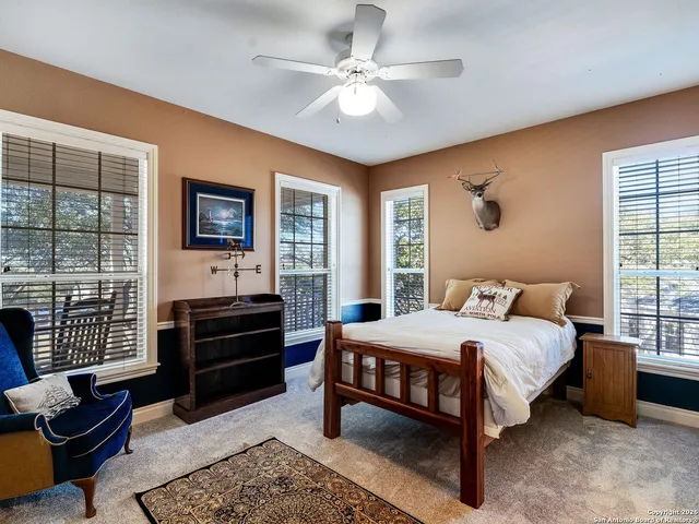 a bathroom with a sink a toilet a mirror and shower curtain