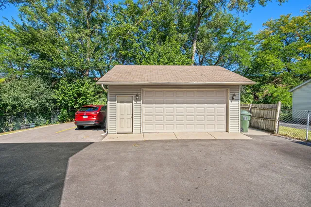 a view of a house with a garage and yard