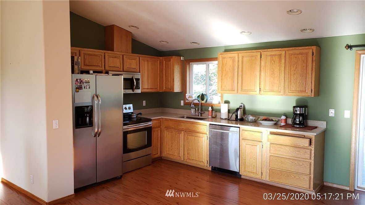 3956 Magrath Road Bellingham, WA 98226 - Photo 3 of 13 a kitchen with a refrigerator stove and sink