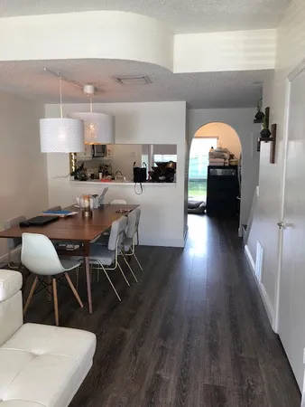 a living room with furniture large window and flat screen tv
