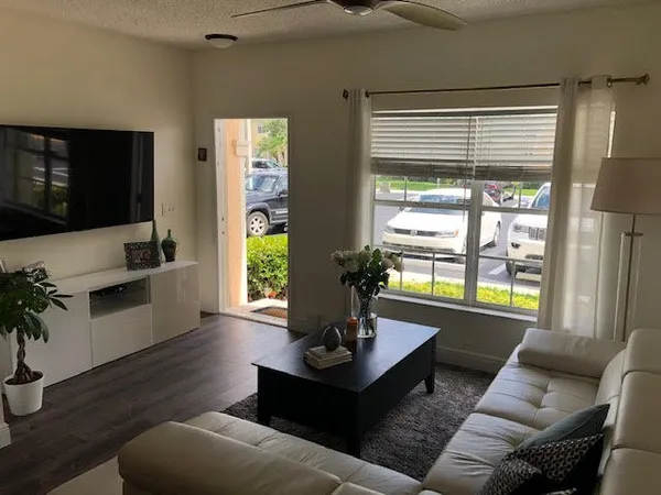 a view of a hallway with wooden floor and stairs