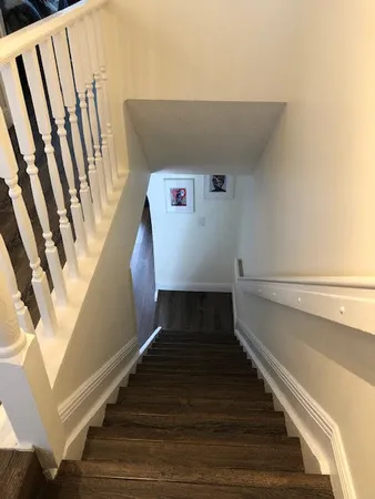 a view of entryway and hall with wooden floor