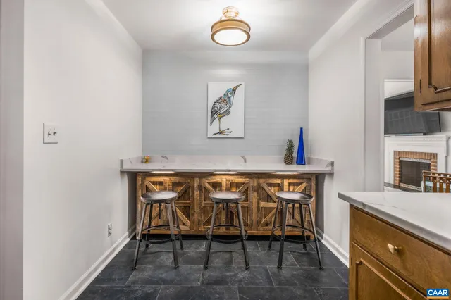 a view of dining room and livingroom with furniture wooden floor a rug and a chandelier