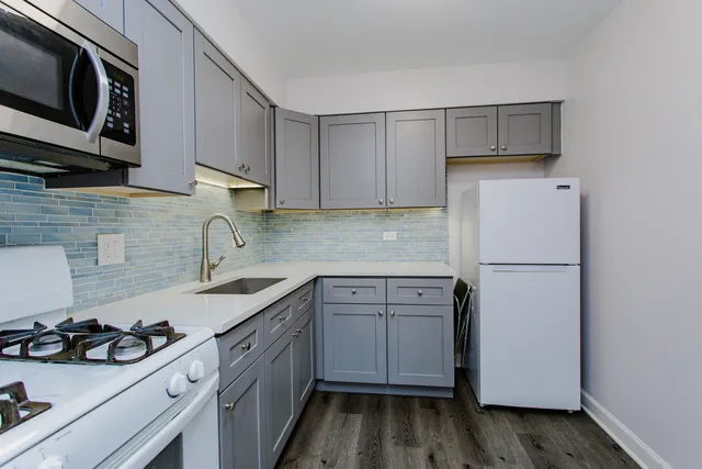 a kitchen with a sink stove and refrigerator