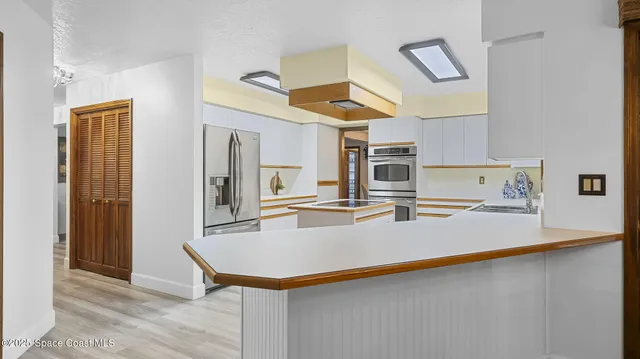 a kitchen that has a sink and a stove