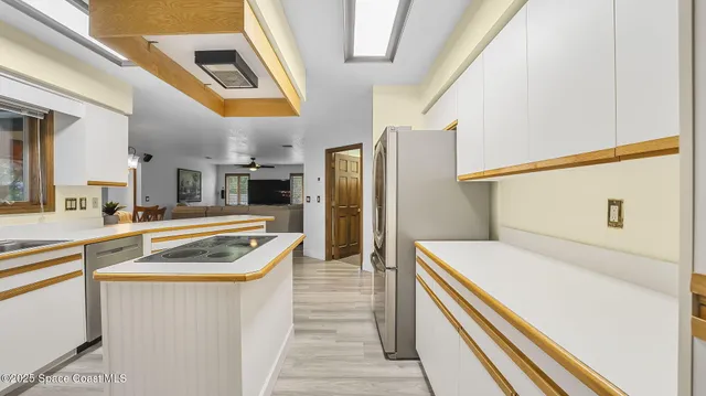 a kitchen with a stove sink and refrigerator