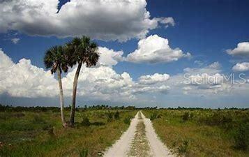 17618 Northwest 286th Street Okeechobee, FL 34972 - Photo 16 of 18 a view of a lake with a yard