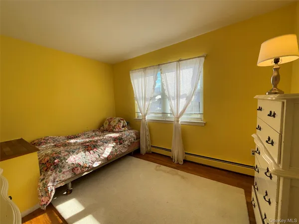 a bed sitting in a bedroom next to a window