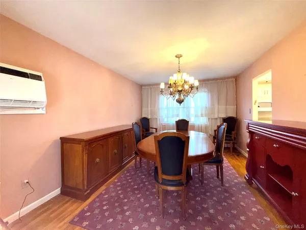 a view of a dining room with furniture and a chandelier