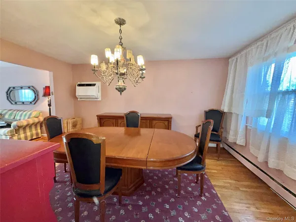 a view of a dining room with furniture and chandelier