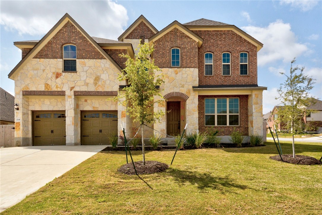 a front view of a house with a yard