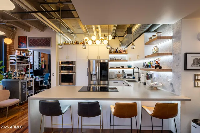 a view of a living room and kitchen with furniture