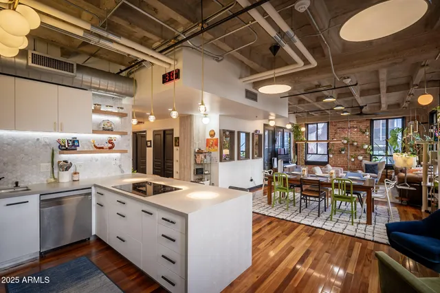 a view of a kitchen with kitchen island a counter space a sink and a refrigerator