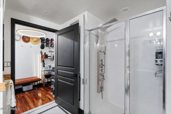 a view of walk in closet with clothes and shoes