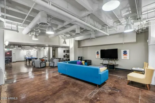 a living room with furniture and a chandelier