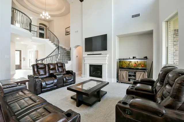 a living room with furniture fireplace and flat screen tv
