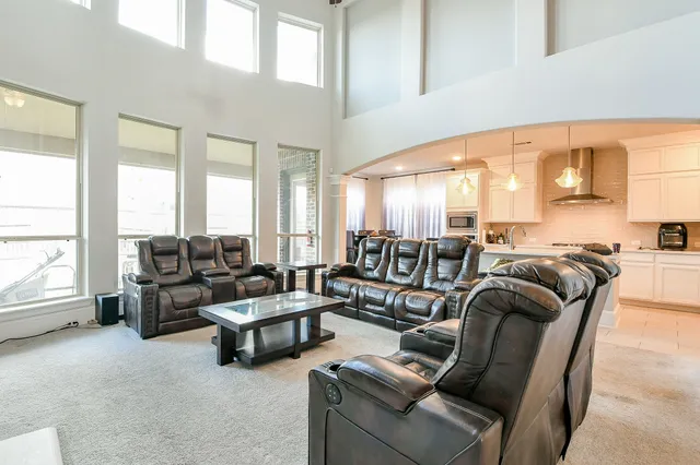 a living room with furniture and large windows