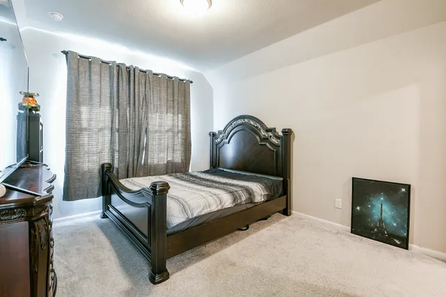 a bedroom with a bed and a mirror