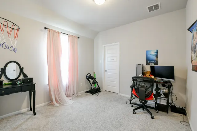 a view of a workspace with furniture and a window