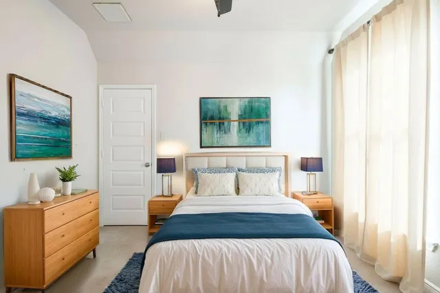 a bedroom with a bed and window