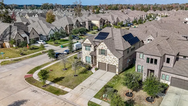 an aerial view of a house with a yard