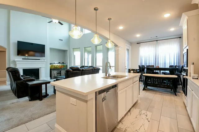 a large white kitchen with a large window