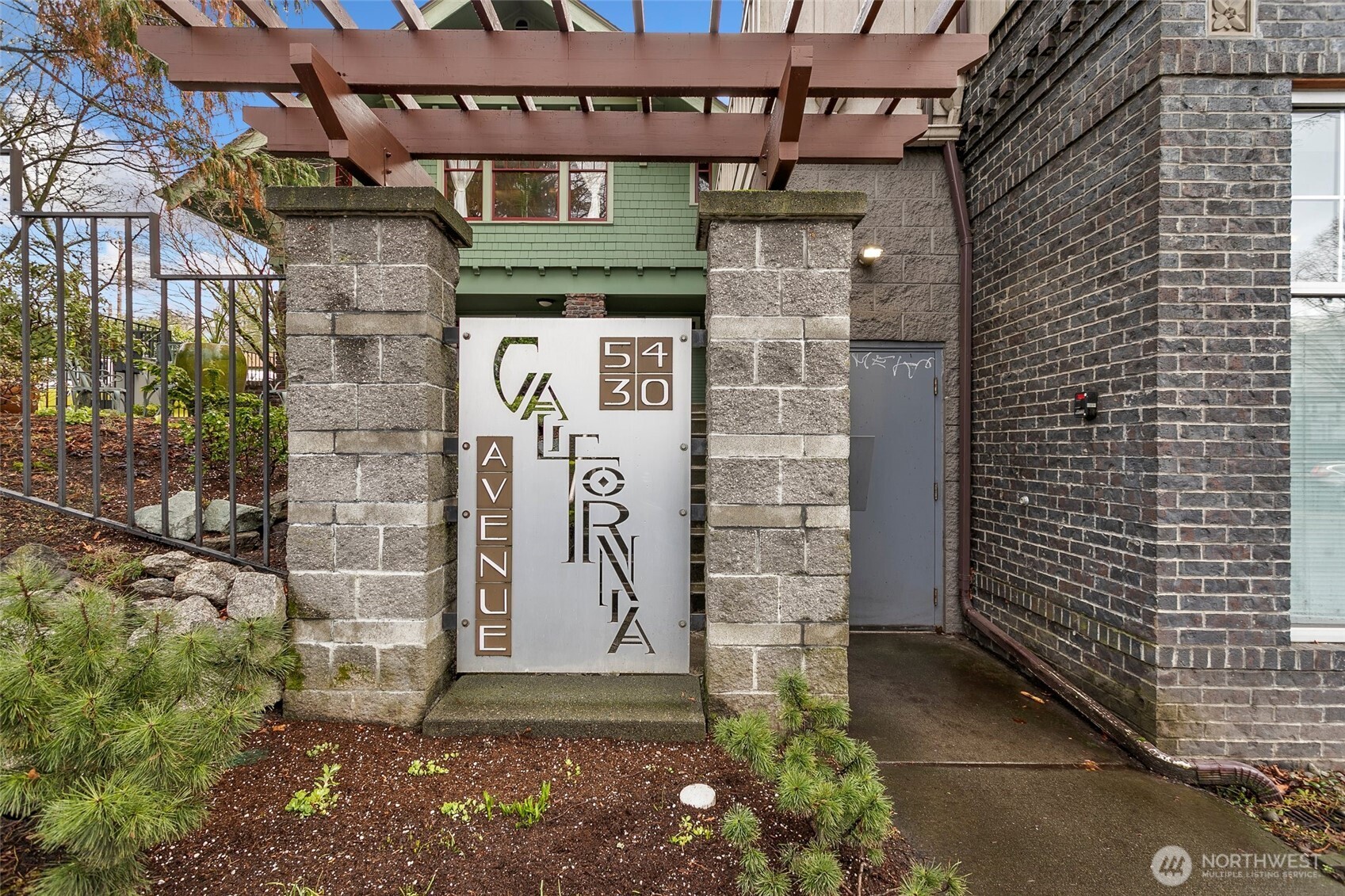 5430 California Avenue Southwest, Unit 3A Seattle, WA 98136 - Photo 2 of 32 a brick building with a door and a window