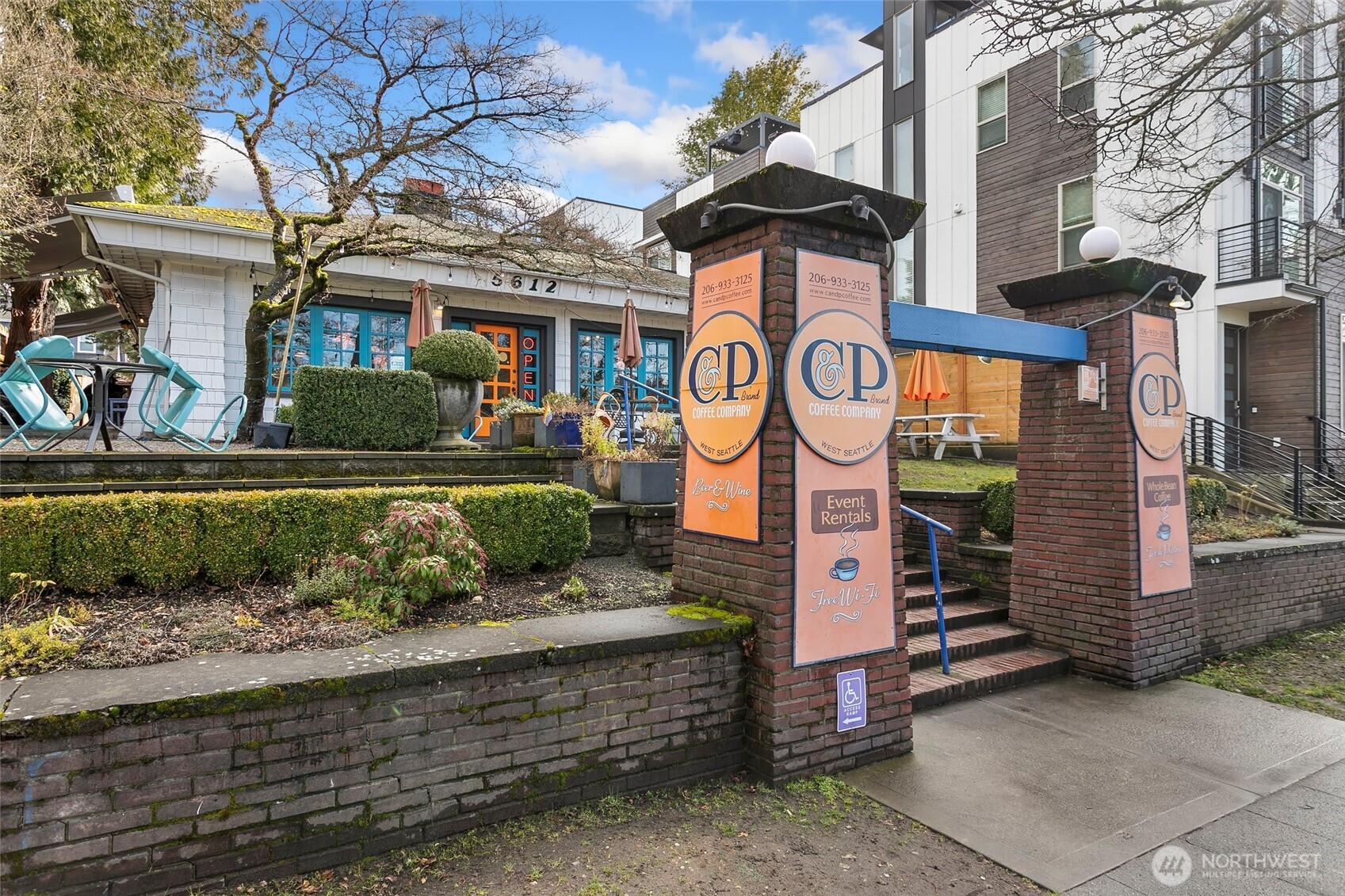 5430 California Avenue Southwest, Unit 3A Seattle, WA 98136 - Photo 27 of 32 a front view of a house with a yard and potted plants