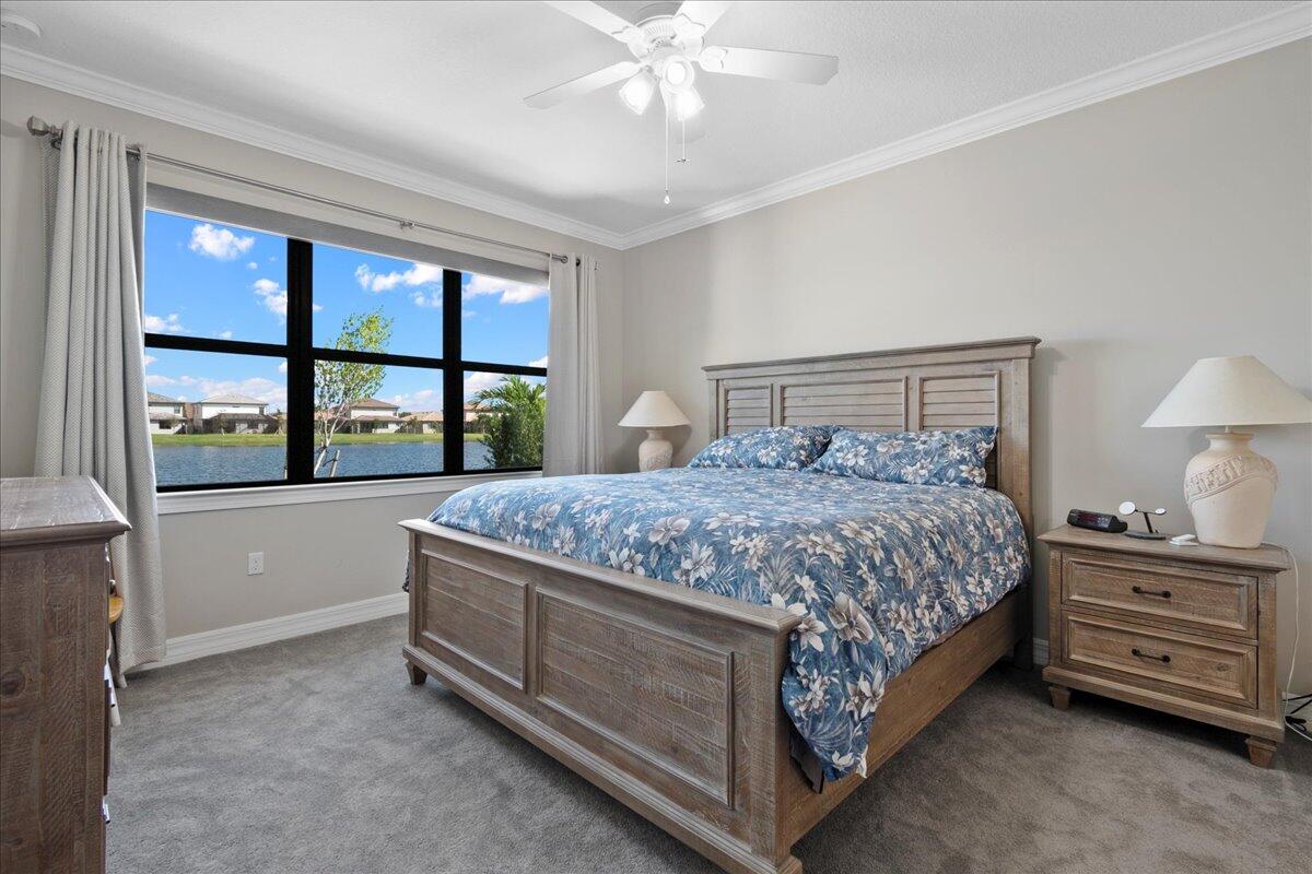 8311 Pedigree Circle Lake Worth, FL 33467 - Photo 11 of 37 a bedroom with a bed and a large window