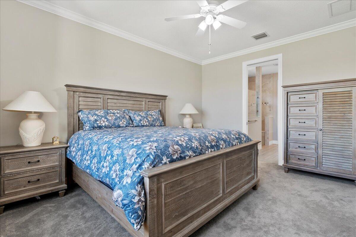 8311 Pedigree Circle Lake Worth, FL 33467 - Photo 12 of 37 a bedroom with a bed and a dresser