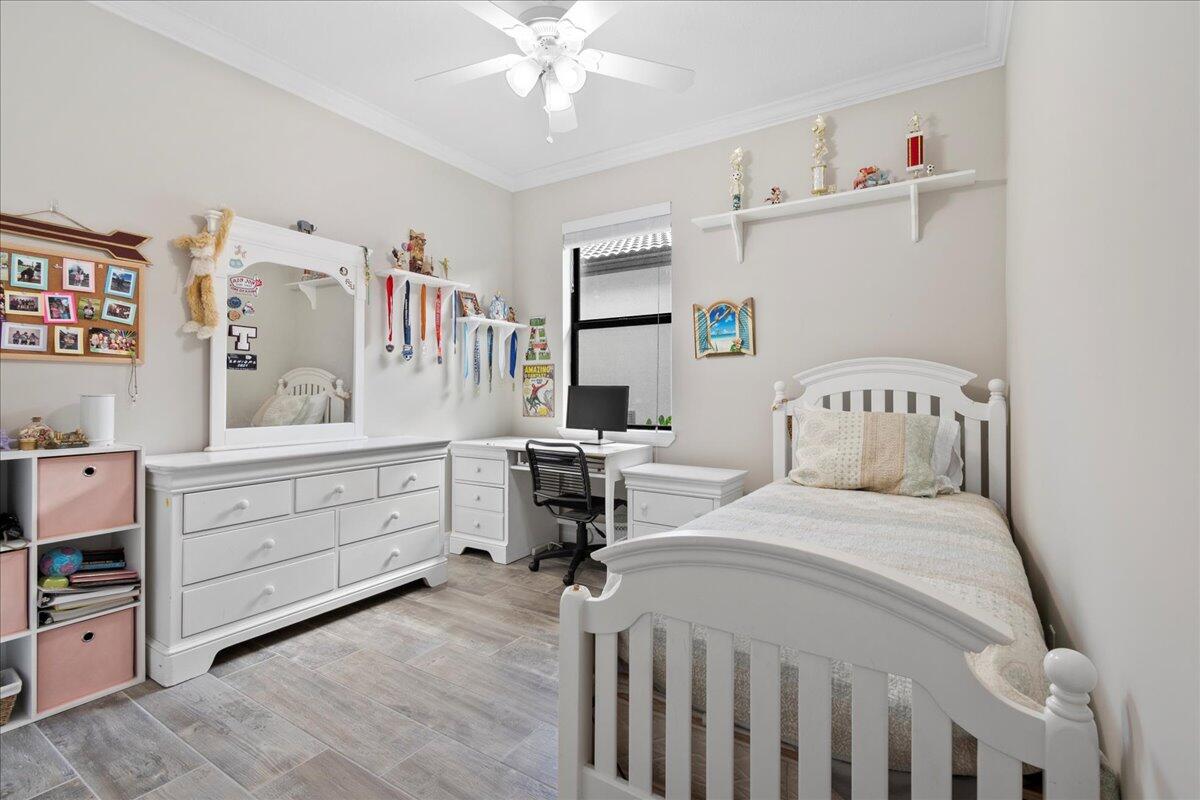 8311 Pedigree Circle Lake Worth, FL 33467 - Photo 16 of 37 a bedroom with a bed and a cabinets