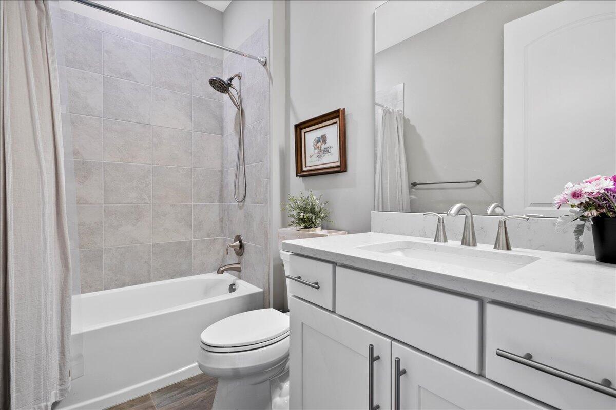 8311 Pedigree Circle Lake Worth, FL 33467 - Photo 17 of 37 a bathroom with a sink a toilet and a bathtub