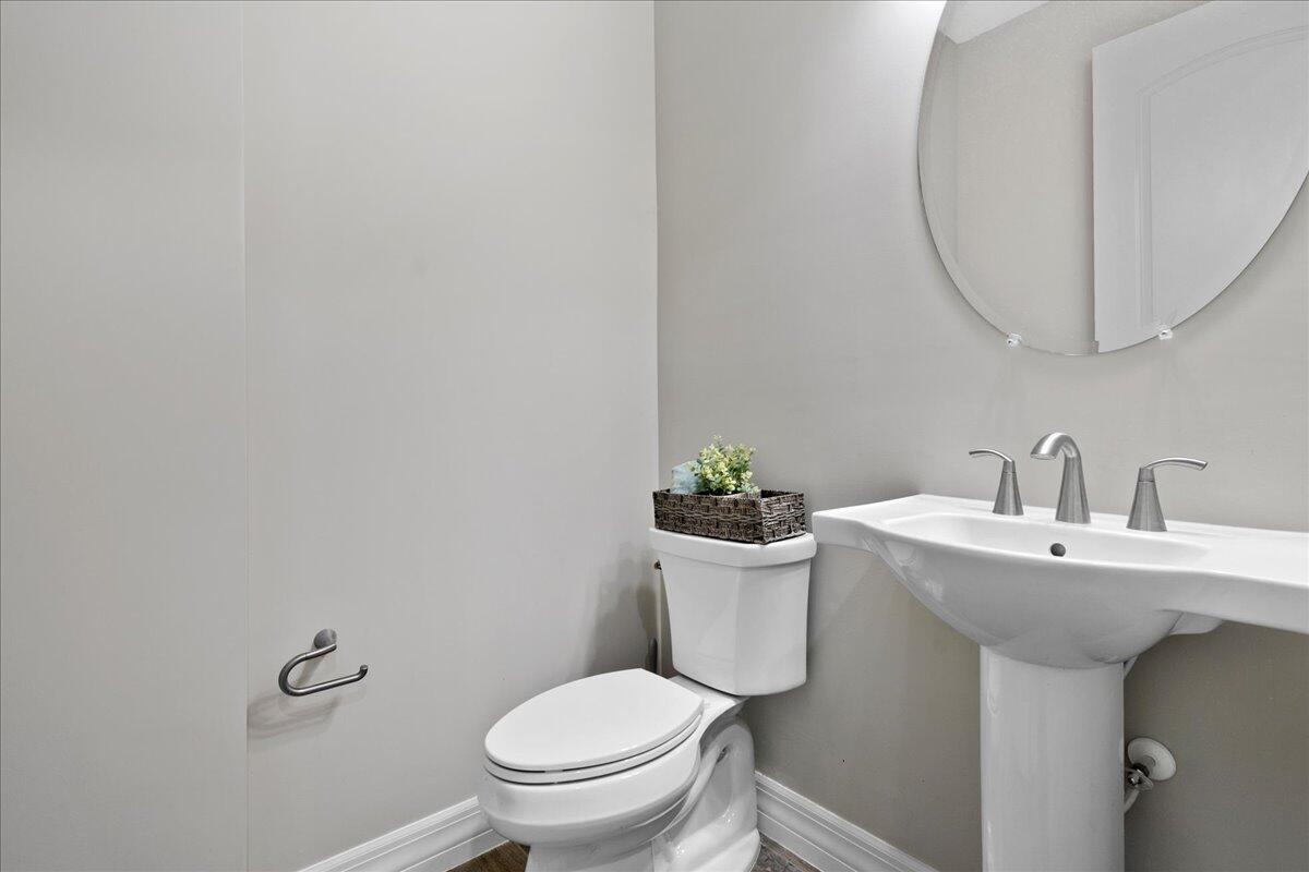 8311 Pedigree Circle Lake Worth, FL 33467 - Photo 19 of 37 a white toilet sitting next to a bathroom sink