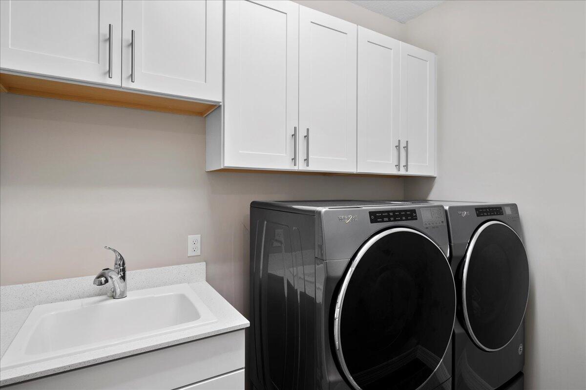 8311 Pedigree Circle Lake Worth, FL 33467 - Photo 20 of 37 a bathroom with a sink and a washer dryer