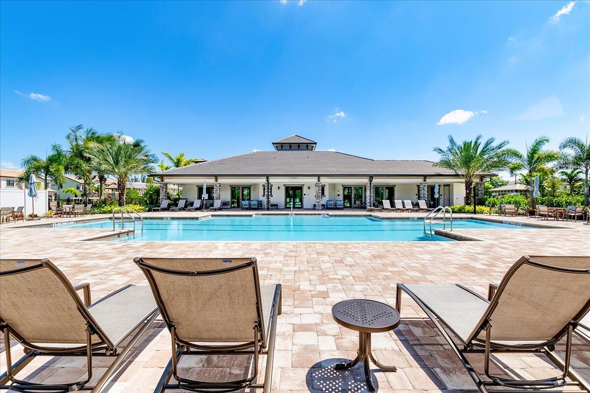 8311 Pedigree Circle Lake Worth, FL 33467 - Photo 25 of 37 a view of a chairs and table in patio with a swimming pool