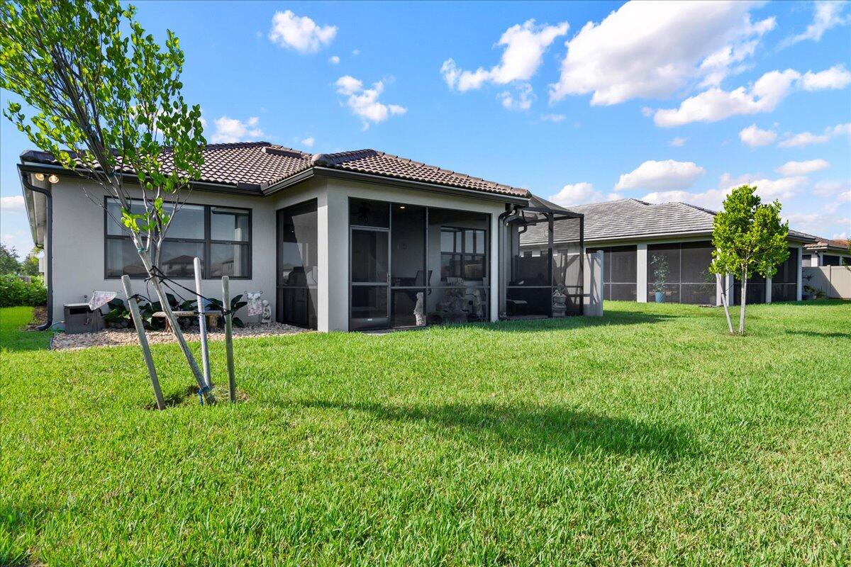8311 Pedigree Circle Lake Worth, FL 33467 - Photo 3 of 37 a view of a house with a yard and plants