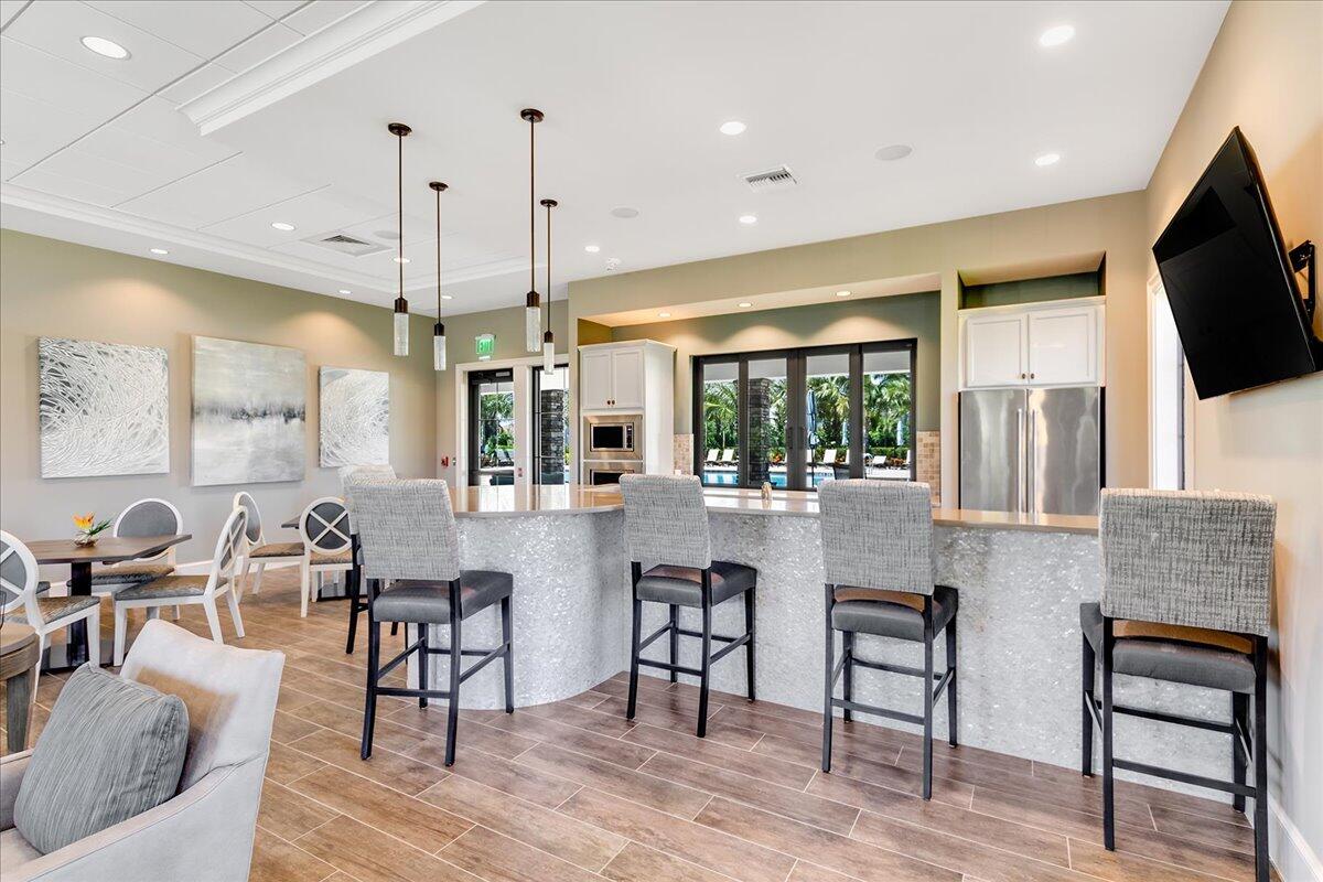 8311 Pedigree Circle Lake Worth, FL 33467 - Photo 35 of 37 a living room with furniture a flat screen tv and kitchen view