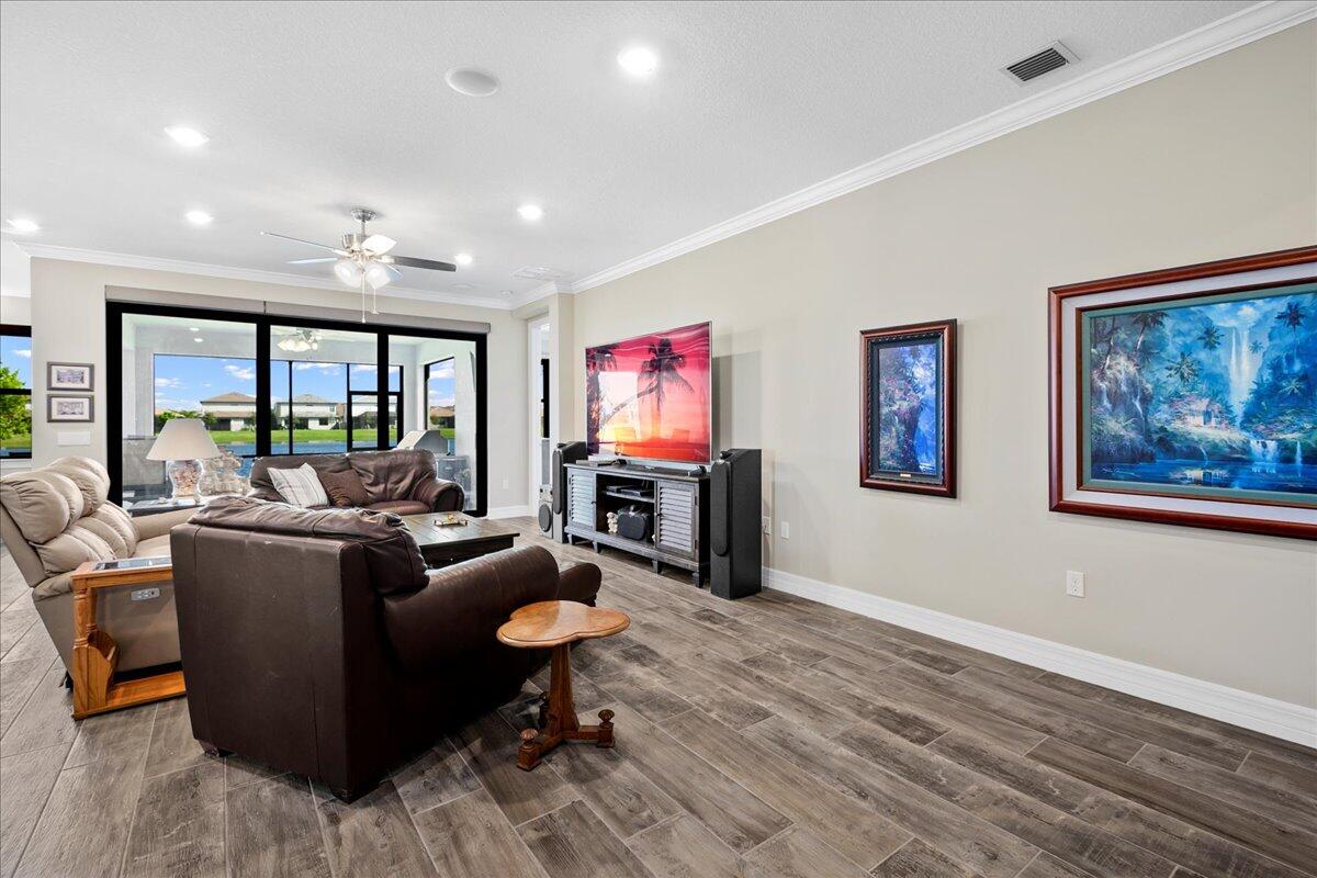 8311 Pedigree Circle Lake Worth, FL 33467 - Photo 10 of 37 a living room with furniture a rug and a flat screen tv