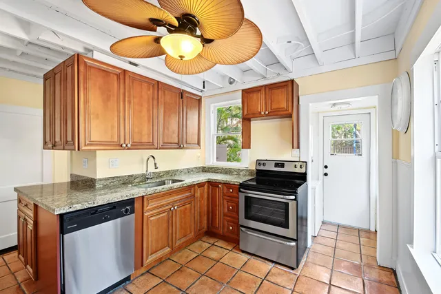 a kitchen with stainless steel appliances granite countertop a sink and cabinets