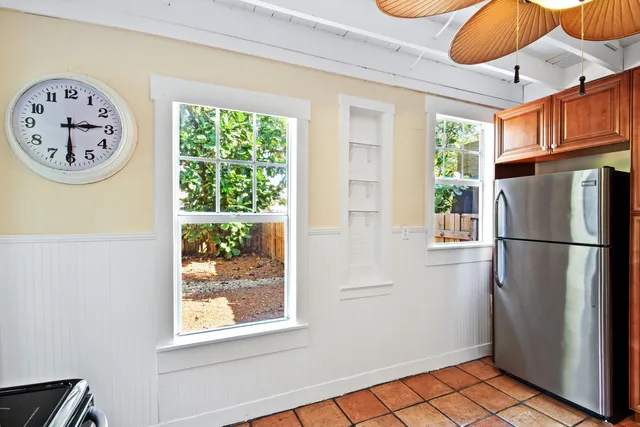 a view of a refrigerator and a window in a room