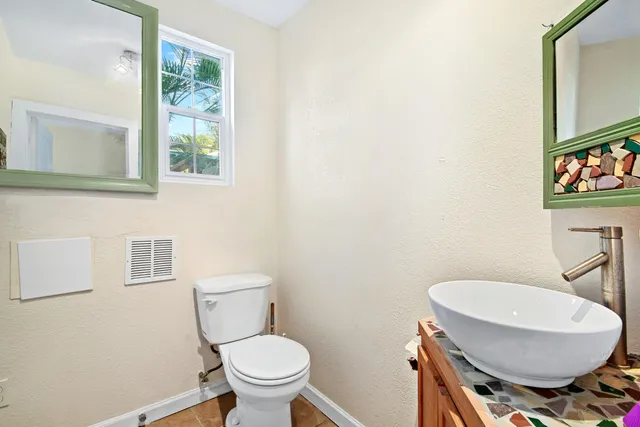 a bathroom with a toilet a sink and a mirror