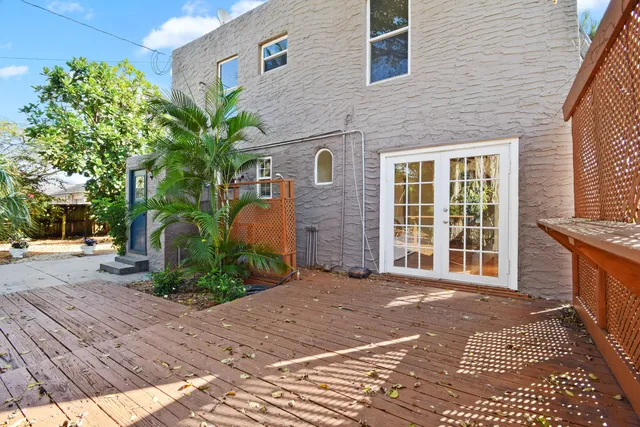 a view of a patio with couple of chairs and potted plants