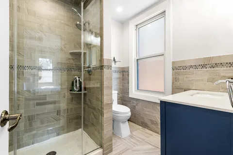 a bathroom with a sink toilet and shower