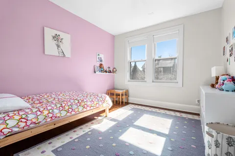 a bedroom with furniture and a window