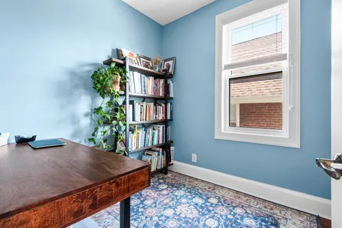 a bedroom with a bed and a book shelf