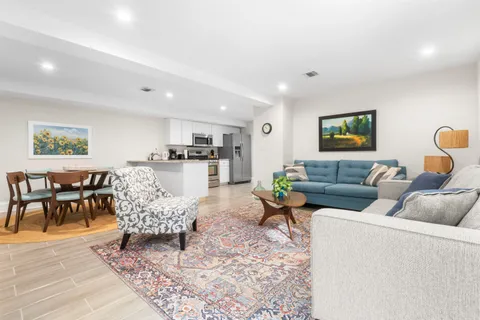 a living room with furniture and kitchen view