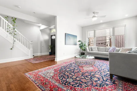 a living room with furniture and wooden floor